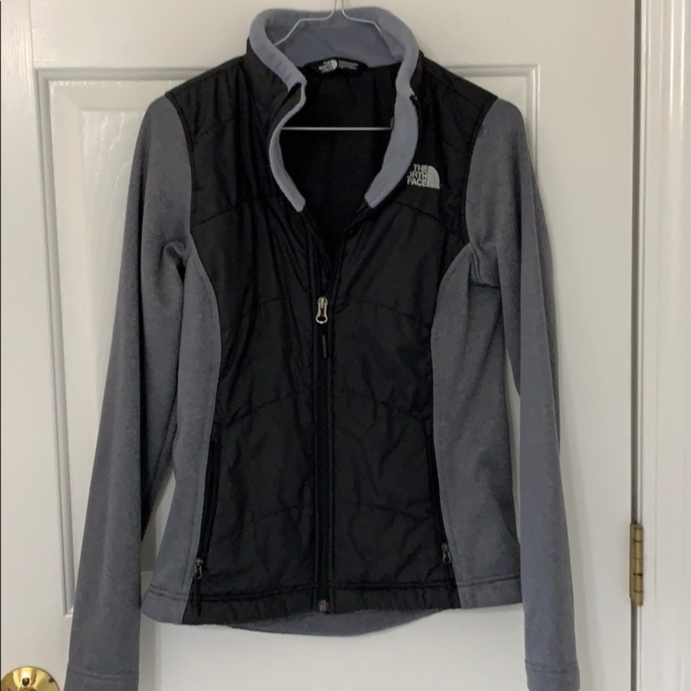 Woman’s grey and black north face jacket